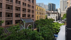 A cityscape with a variety of buildings, including a yellow building labeled "Leadership House" and a large brown building with a grid-like facade. - Modern Venetian Elegance in CBD (Cape Town)