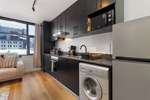 Fridge, microwave, oven, stovetop - Urban Luxe Apartment | Rooftop Pool and Gym (Cape Town)
