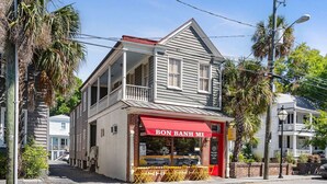 A two-story building with a red awning and the sign "BON BANH MI". - 2BR/2BA Downtown Charleston on Spring St + Parking (Charleston)