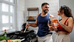 A kitchen with a stove, a cutting board with vegetables, and a person cooking. - 2bdrs With Copacabana Beach View A 2936/1202 (Rio de Janeiro)
