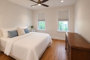 A bedroom with a bed, bedside table, nightstand, and a dresser. - Historic 3BR Rowhome + Parking Near Union Market (Washington)