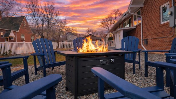 A patio with a fire pit, outdoor seating, and a view of a sunset. - 
Hot Tub • Walk Downtown • Sleeps 11 • Near Royal Gorge (Cañon City)