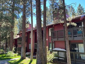 A multi-story building with balconies, surrounded by tall trees. - Cal King, 2BR/2bth Hot Tub, Pool & Walk to town (Mammoth Lakes)