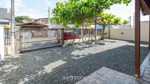 A gated residential area with a gravel driveway and a tree providing shade. - House w/ Barbecue 600 m From the Beach Nus0636 (Picarras)