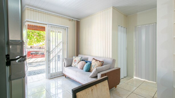 A modern living room with a sofa, a coffee table, and a sliding glass door leading to an outdoor area. - House w/ Barbecue 600 m From the Beach Nus0636 (Picarras)