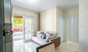 A modern living room with a sofa, a coffee table, and a sliding glass door leading to an outdoor area. - House w/ Barbecue 600 m From the Beach Nus0636 (Picarras)