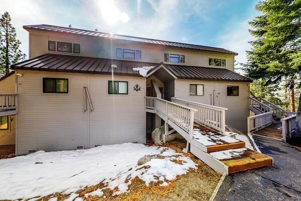 A two-story house with a covered porch and a staircase leading to the upper floor. - Eagle's Nest - Condo in Huntington Lake (Big Creek)