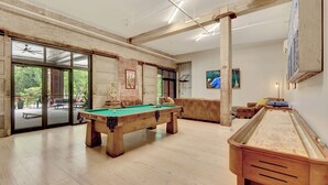 A spacious indoor recreational area with a pool table, a foosball table, and a billiards table. - Pythian Studio #103-Walking distance to downtown Hot Springs & 6 min to Oaklawn! (Hot Springs)