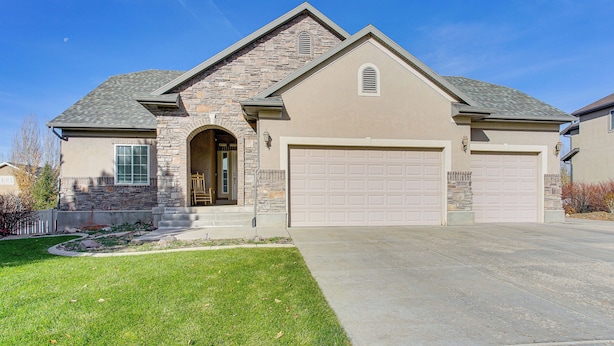 A two-story house with a stone facade, a garage, and a well-maintained lawn. - Park City Area Lodge: 9 Mi to Timber Lakes (Heber City)
