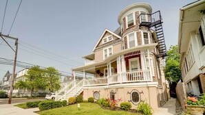A two-story house with a wrap-around porch, a bay window, and a small balcony. - Walk to Beach & Boardwalk: Ocean City Haven! (Ocean City)