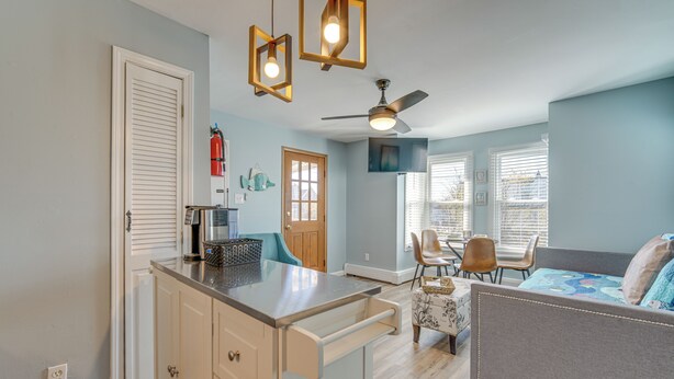 A compact living space with a kitchenette, a dining area, and a seating area. - Walk to Beach & Boardwalk: Ocean City Haven! (Ocean City)