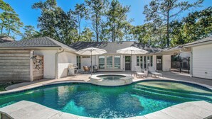 A backyard with a swimming pool, outdoor furniture, and a barbecue area. - Chic TX House w/ Pool and Relaxing Atmosphere (Spring)