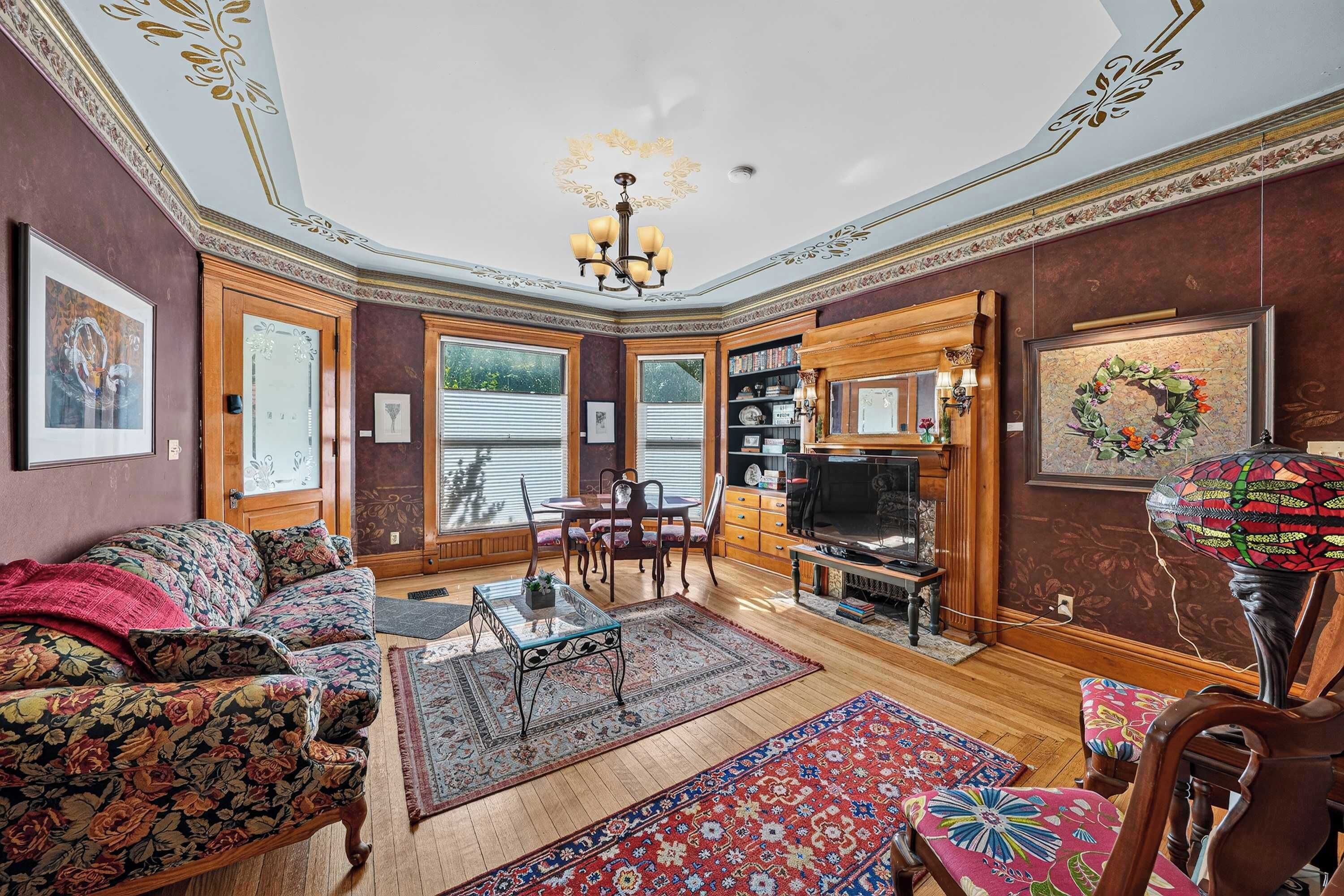 A traditional living room with a sofa, coffee table, and television.