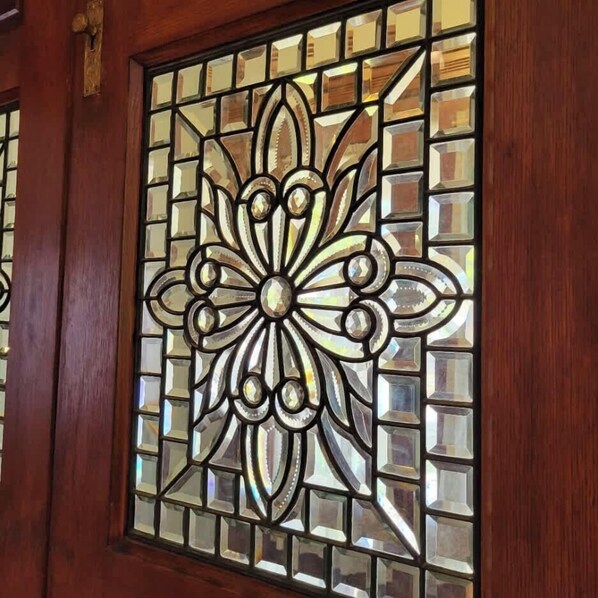 A stained glass window with a geometric floral pattern. - Historic South Bend Home: Art, Comfort & Charm (South Bend)