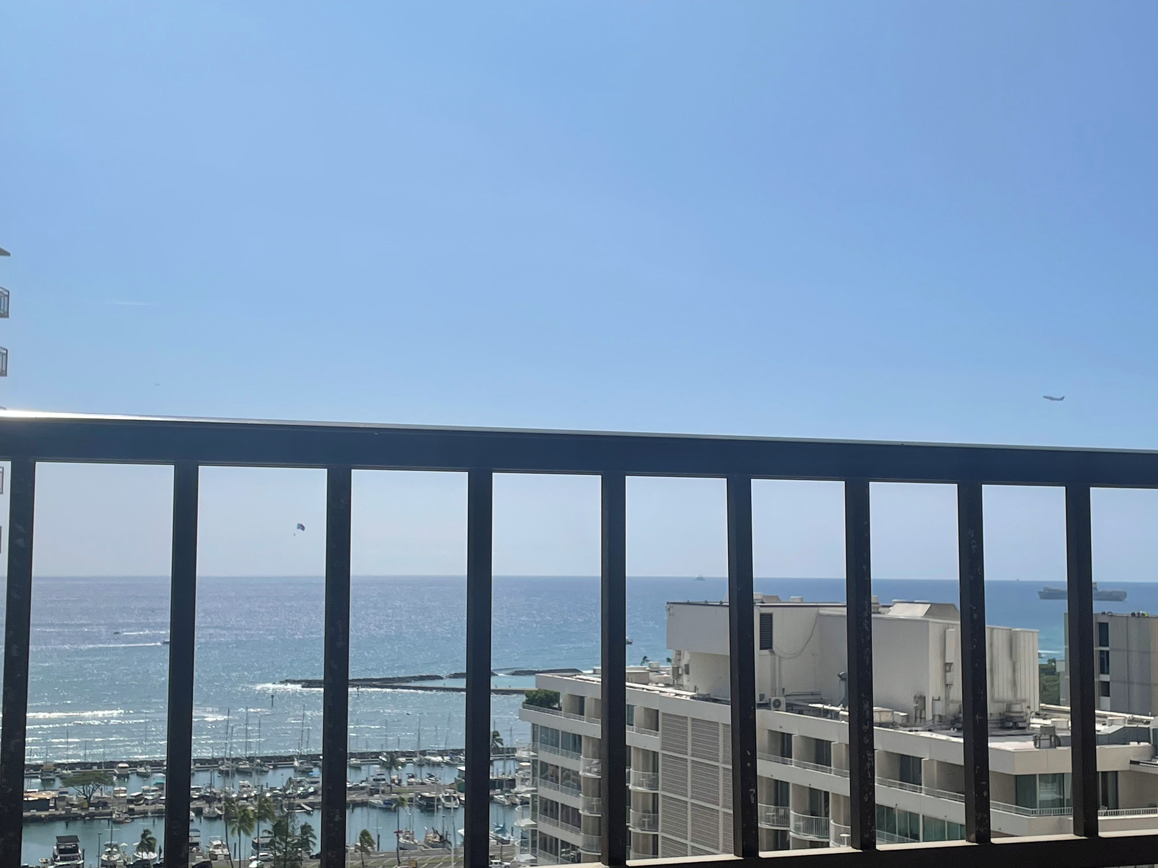 A balcony with a view of a marina and buildings.
