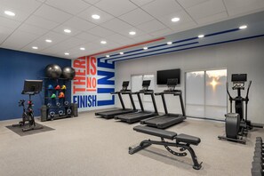 A gym with treadmills, an exercise bike, and weight machines.