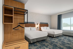 A hotel room with two beds, a wooden wardrobe, a hanging rack, and a large window with a view. - Hampton Inn By Hilton Lawrenceburg (Lawrenceburg)