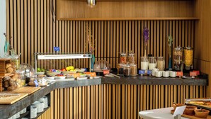 A breakfast buffet with various food items and condiments. - Hampton By Hilton Ben Guerir (Ben Guerir)