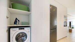 A modern kitchen with a built-in washer and dryer, a stainless steel refrigerator, and a microwave. - Casa Xabi, Private terrace - Puerto del Carmen (Puerto del Carmen)