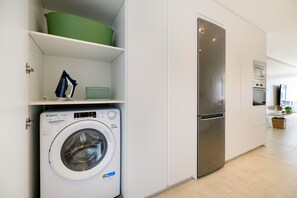 A modern kitchen with a built-in washer and dryer, a stainless steel refrigerator, and a microwave. - Casa Xabi, Private terrace - Puerto del Carmen (Puerto del Carmen)