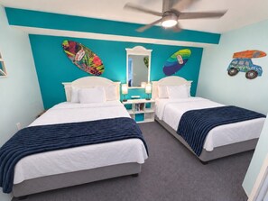 A hotel room with two beds, a ceiling fan, a mirror, and artwork on the walls. - 7TH HEAVEN! PRIME LOCATION IN MB (Myrtle Beach)