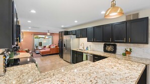 A modern kitchen with dark cabinets, granite countertops, and stainless steel appliances. - Resort Pool | Private Hot Tub | Close to Old Town (Scottsdale)