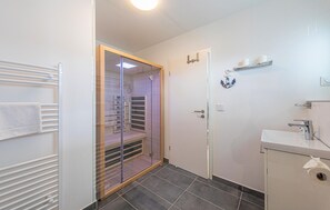 A bathroom with a shower, a toilet, a sink, and a towel rack. - Awesome apartment in OstseeResort Olpenitz (OstseeResort Olpenitz)