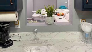 A kitchen with a marble countertop, a coffee machine, and a wine glass. - Downtown Harrisburg close to Hershey PA-Sleeps 8 (Harrisburg)