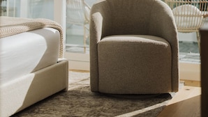 A modern living room with a large window, a beige armchair, and a white sofa. - NEW Queen Anne View Retreat | Sleeps 8 w/ A/C (Seattle)