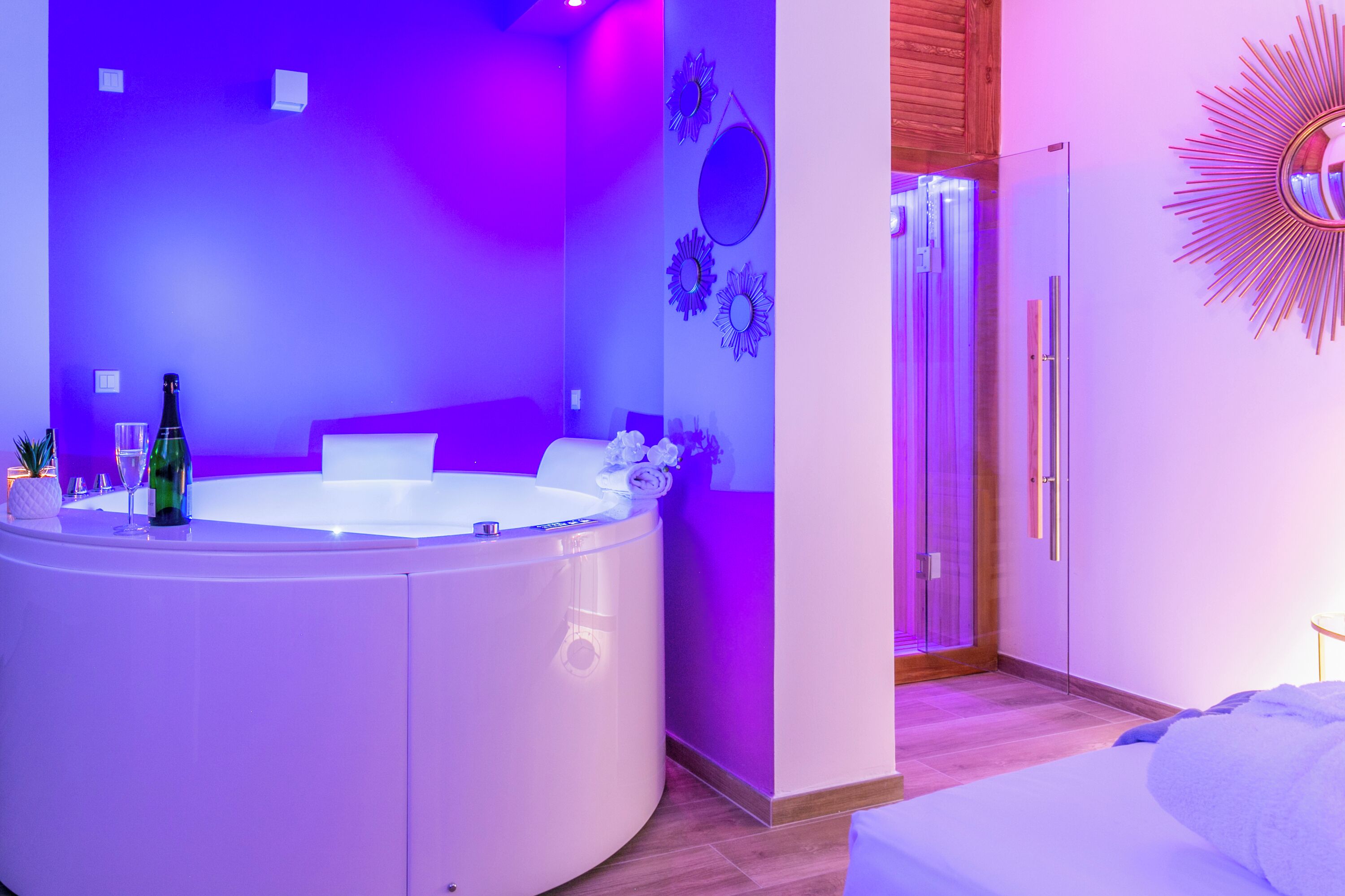 A modern bathroom with a large bathtub, a shower area, and a vanity with a mirror.