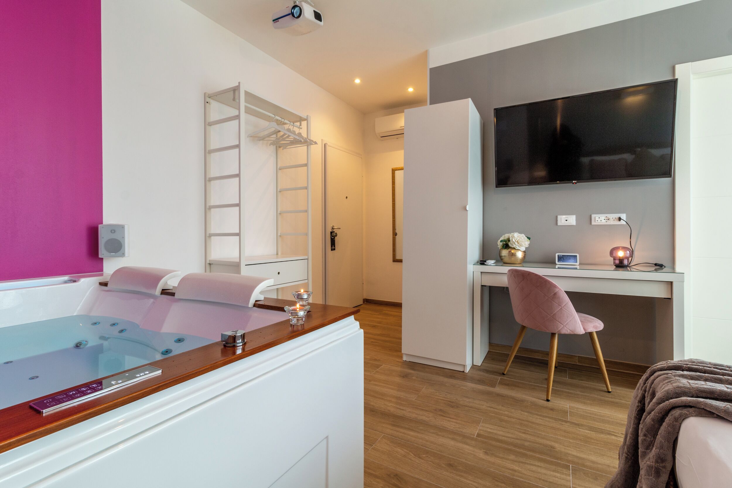A modern bathroom with a glass-enclosed shower, a wooden vanity, and a built-in ladder.