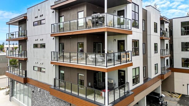 A multi-story residential building with balconies, large windows, and a modern architectural design. - New 2BR in DT Golden AC, Balcony, BBQ, Sleeps 6 (Golden)