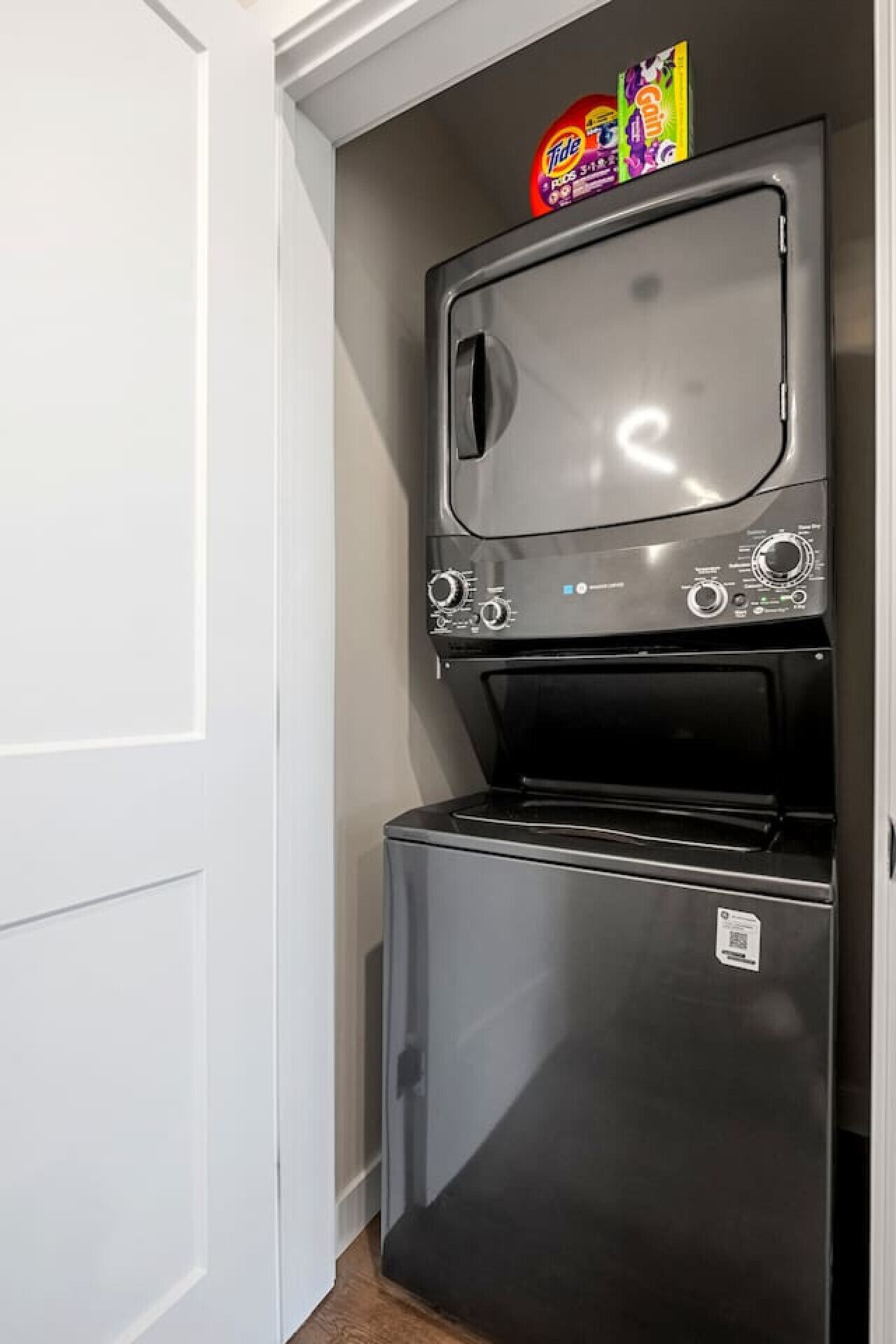 A compact kitchen with a built-in microwave and refrigerator.