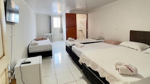 A hotel room with two beds, a TV, a desk, and a bathroom visible through an open door. - Pousada Rancho do Sabiá (Baraúna)