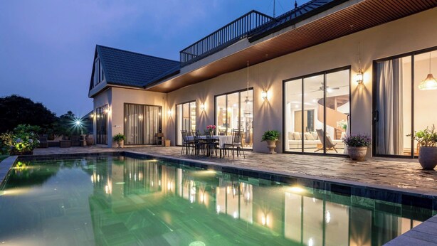 A modern house with a swimming pool, large windows, and outdoor furniture. - Velia Villa Sóc Sơn (Hanoi)