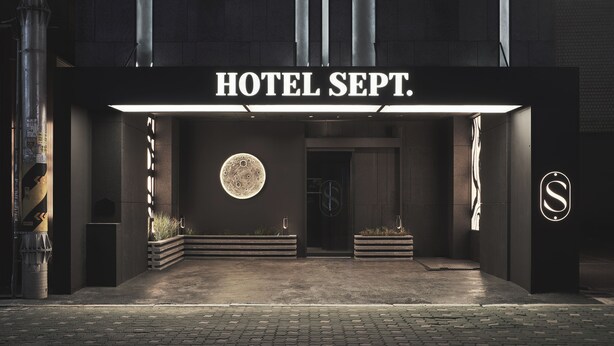 A hotel entrance with a sign reading "HOTEL SEPT." and a circular moon-like design on the wall. - Guwol Hotel Jongno Ikseon (Seoul)