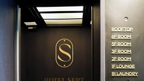 An elevator interior with a sign indicating 'HOTEL SEPT.' and room numbers including '6F ROOM', '5F ROOM', '3F ROOM', '2F ROOM', '1F LOUNGE', and 'B1 LAUNDRY'. - Guwol Hotel Jongno Ikseon (Seoul)
