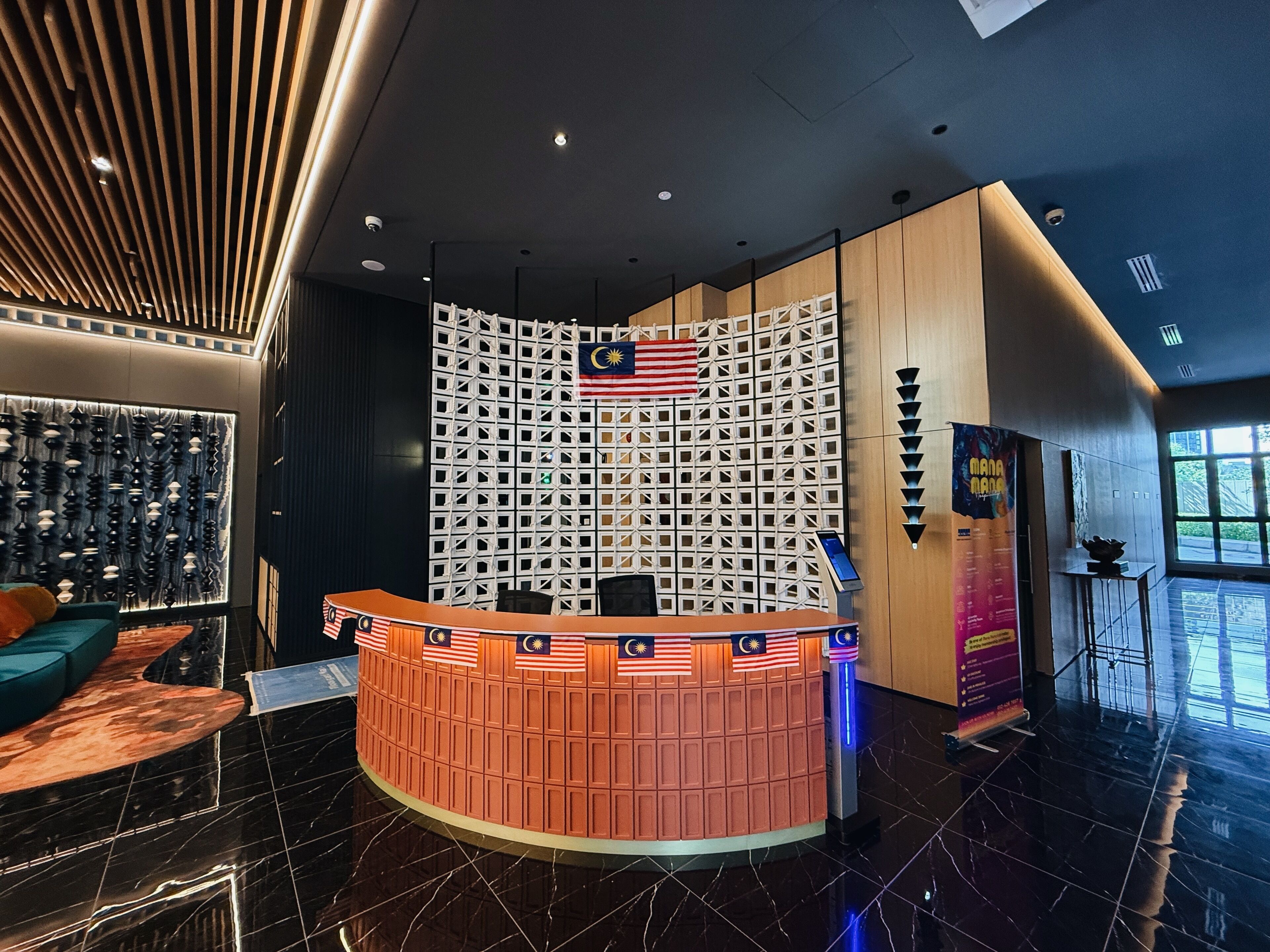 A reception area with a curved counter, a flag, and a patterned wall.