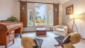 A room with a wooden desk, a cushioned bench, a sofa, and a standing lamp. - Slope View - Parkdale Perfection, Views For Miles, Gorgeous! (Mount Hood Parkdale)