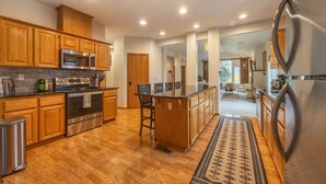 A modern kitchen with wooden cabinets, stainless steel appliances, and a central island. - Slope View - Parkdale Perfection, Views For Miles, Gorgeous! (Mount Hood Parkdale)
