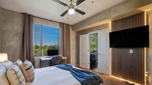 A hotel room with a bed, a desk, a chair, a TV, and a balcony door. - Scottsdale 2BR/2BA • Pool • Gym • Free Parking (Phoenix)
