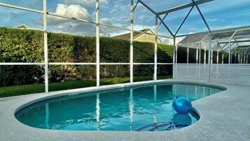An indoor swimming pool with a clear view of the surrounding landscape.
