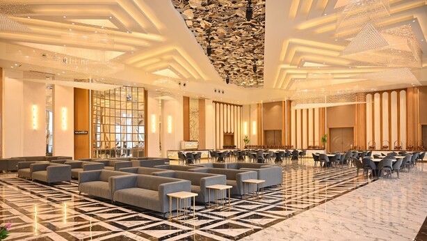 A spacious lobby with seating areas, a reception desk, and a large dining area. - The Hoften Lotus Court, Greater Noida (Greater Noida)