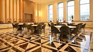 A spacious hotel lobby with a checkered marble floor, multiple seating areas, and large arched windows. - The Hoften Lotus Court, Greater Noida (Greater Noida)