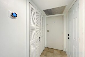 A hallway with a white door, a digital lock, and a vent on the ceiling. - Casagrandesouthbeach by AmericanVacationLiving 4Rm (Miami Beach)