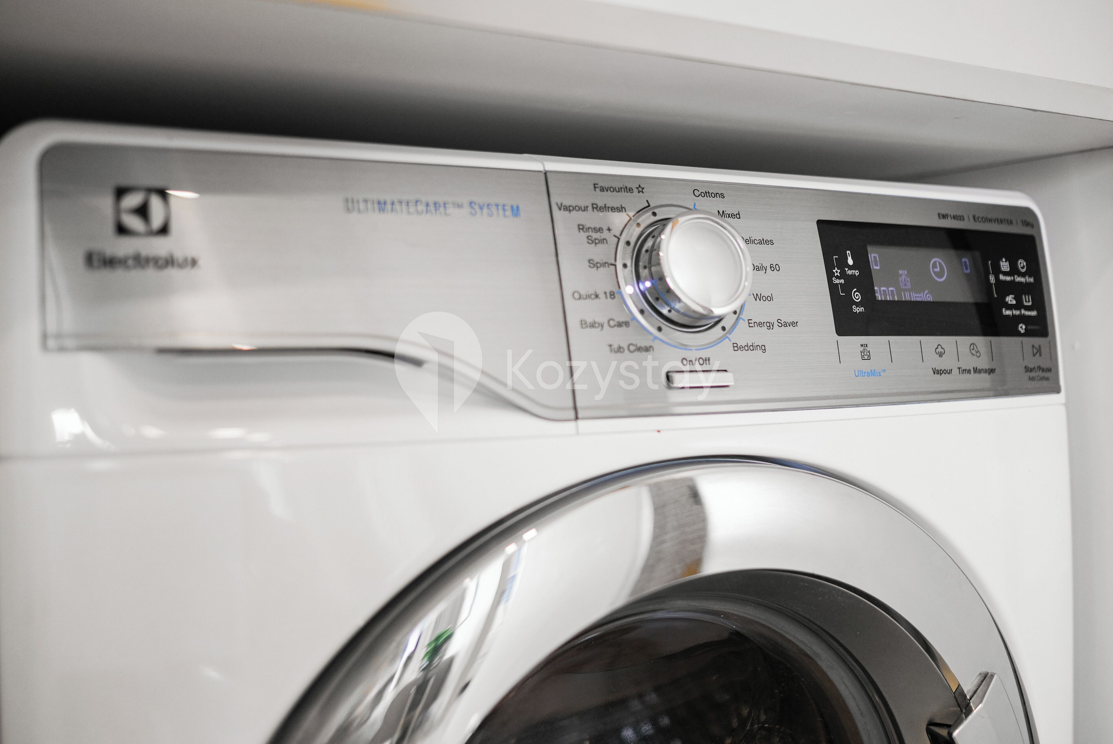 A front view of a washing machine with a control panel displaying various settings and options.