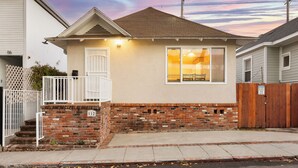 A single-story house with a brick foundation and a gabled roof. - Beach Home with Open Living & Walkability to Abbot Kinney | Venice Drift (Los Angeles)
