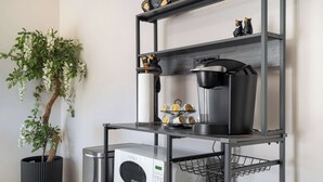 A kitchen with a built-in microwave, a kettle, and a shelf with kitchen utensils. - Trailbend Crossing! Hot Tub near Garden of the Gods (Colorado Springs)