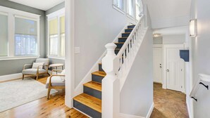 A staircase with wooden steps and white railings, leading to a room with a gray wall and a window. - River Park Retreat! Walk to River, Trails & Town Life (Buena Vista)