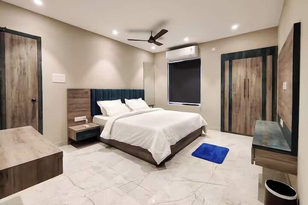 A bedroom with a bed, nightstand, and a ceiling fan.
